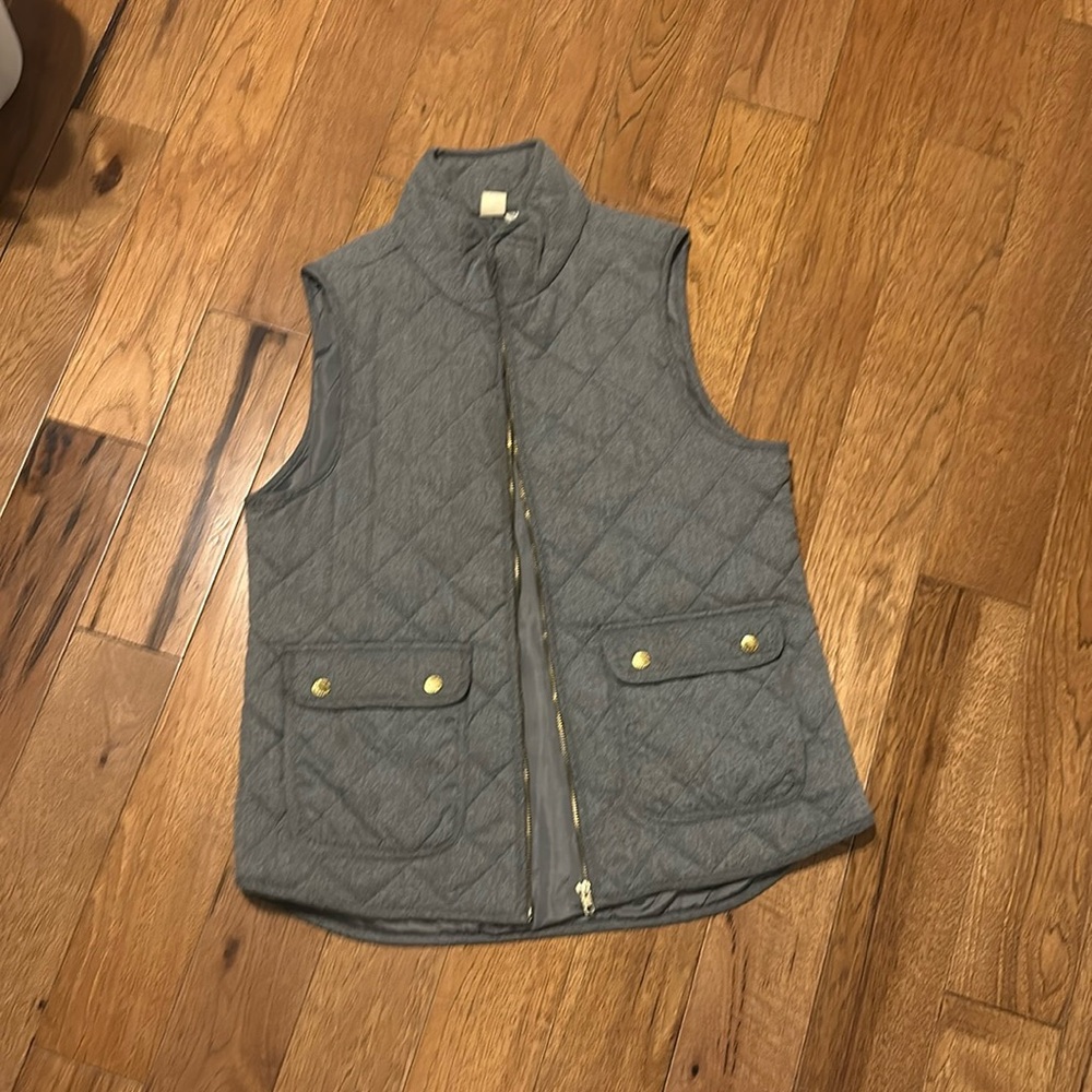 Light gray vest with gold buttons and zipper